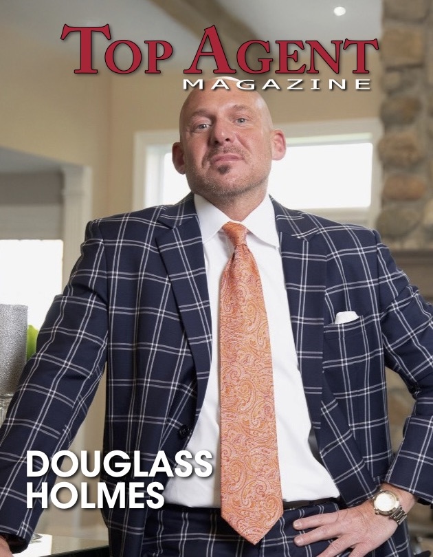 Douglass Holmes on the cover of Top Agent Magazine wearing a suit inside a luxury home.