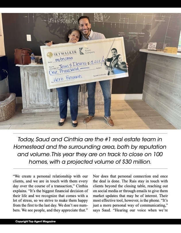 Saud and Cinthia Rai presenting a Hero Rewards check to clients as part of their real estate community program